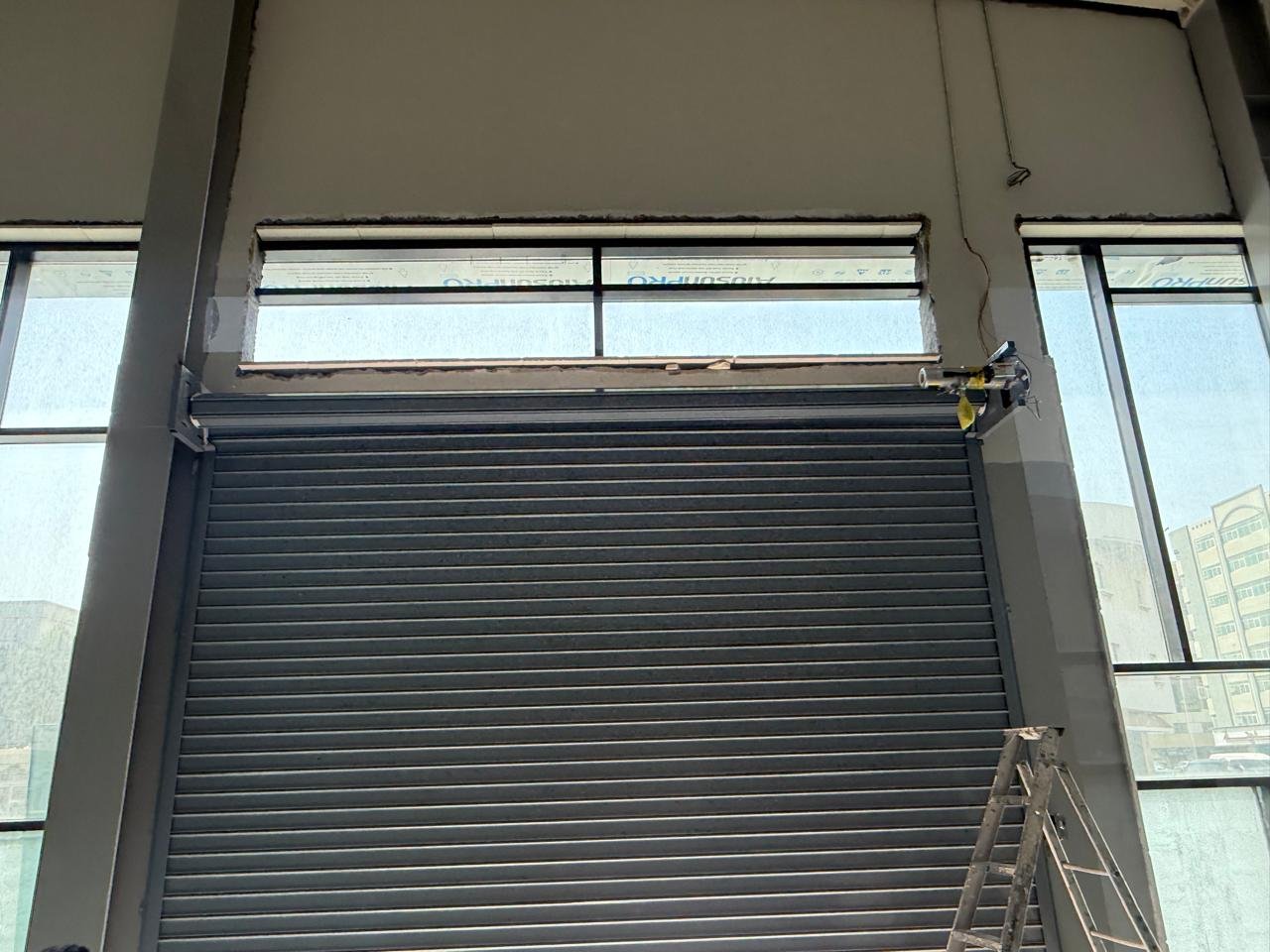 Black rolling shutter on a commercial building