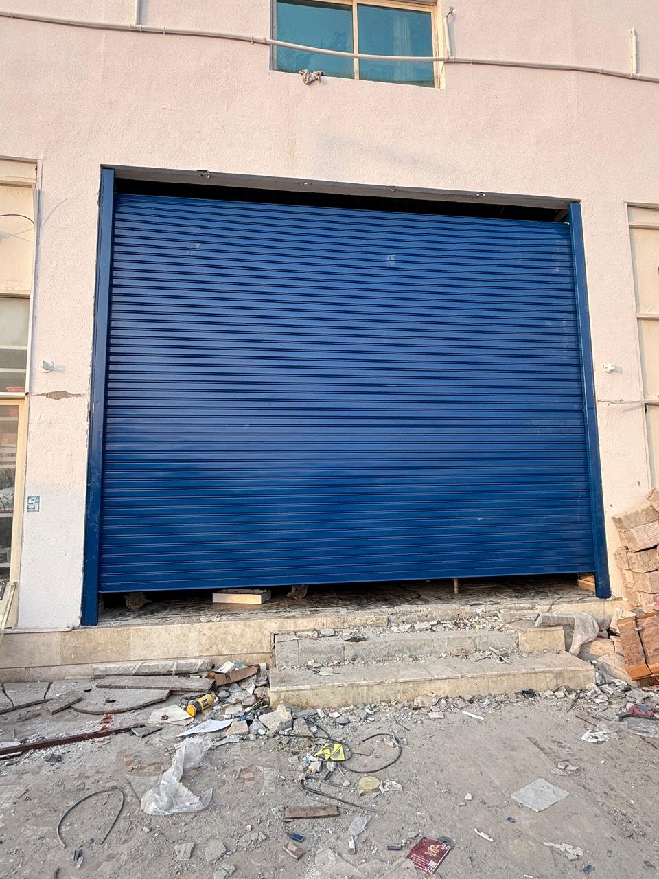 Blue rolling shutter at a warehouse entrance