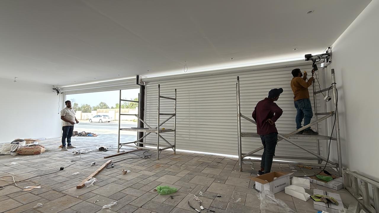 Dubai Shutter Service team installing a rolling shutter in a showroom