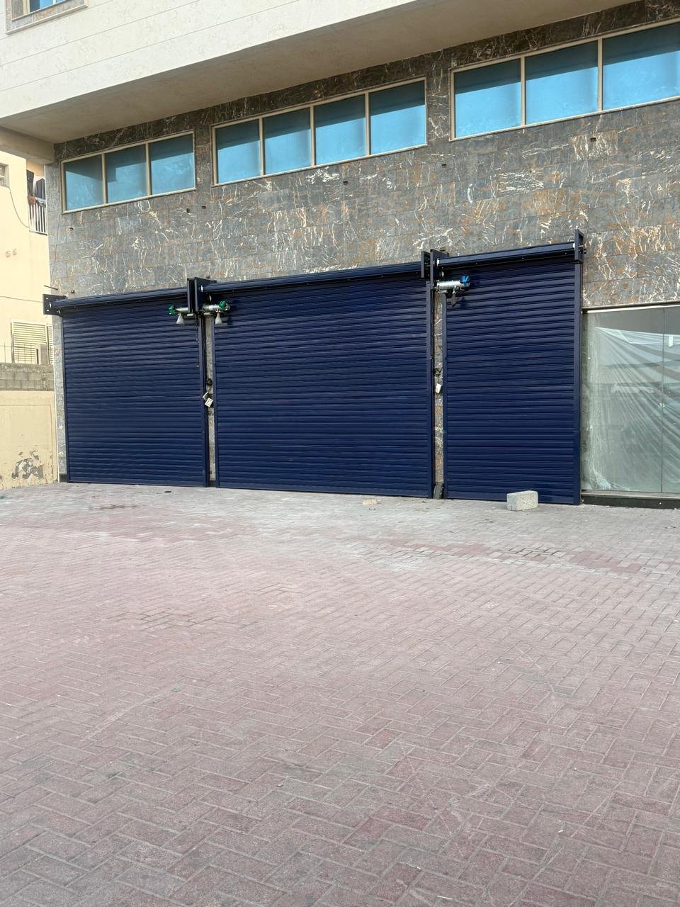 Navy blue rolling shutters closed on a shopfront