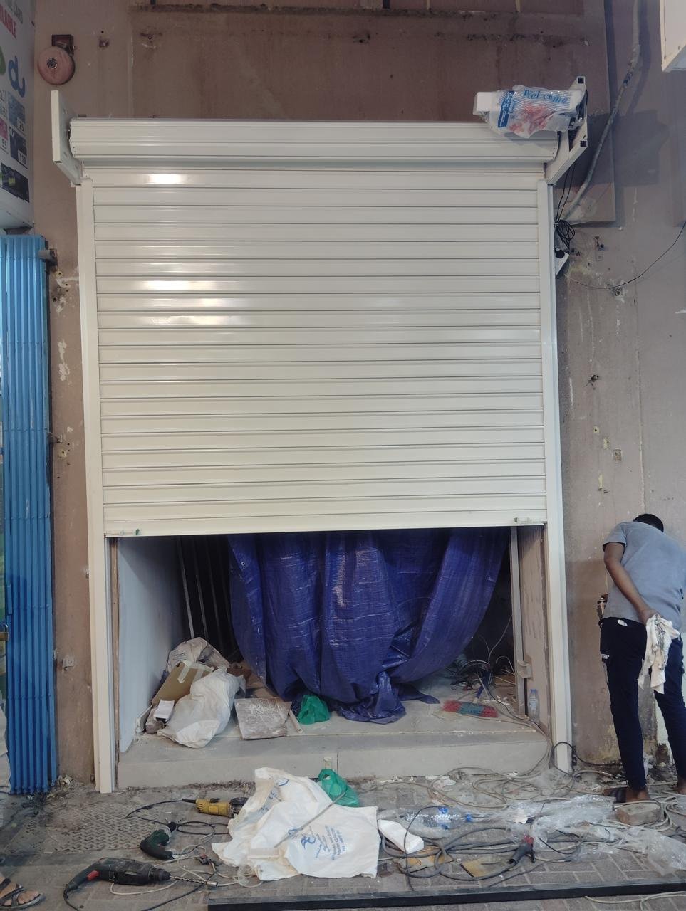 White rolling shutter installation on a shopfront