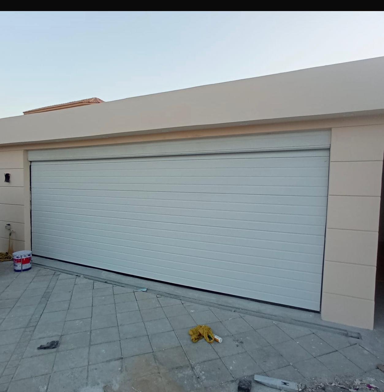 White automatic sectional garage door on a villa