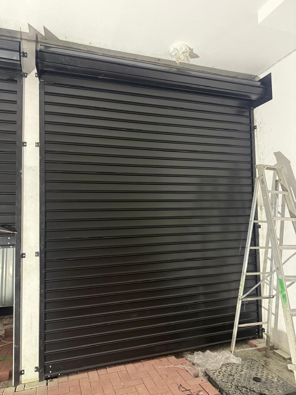 Black rolling shutter being repaired