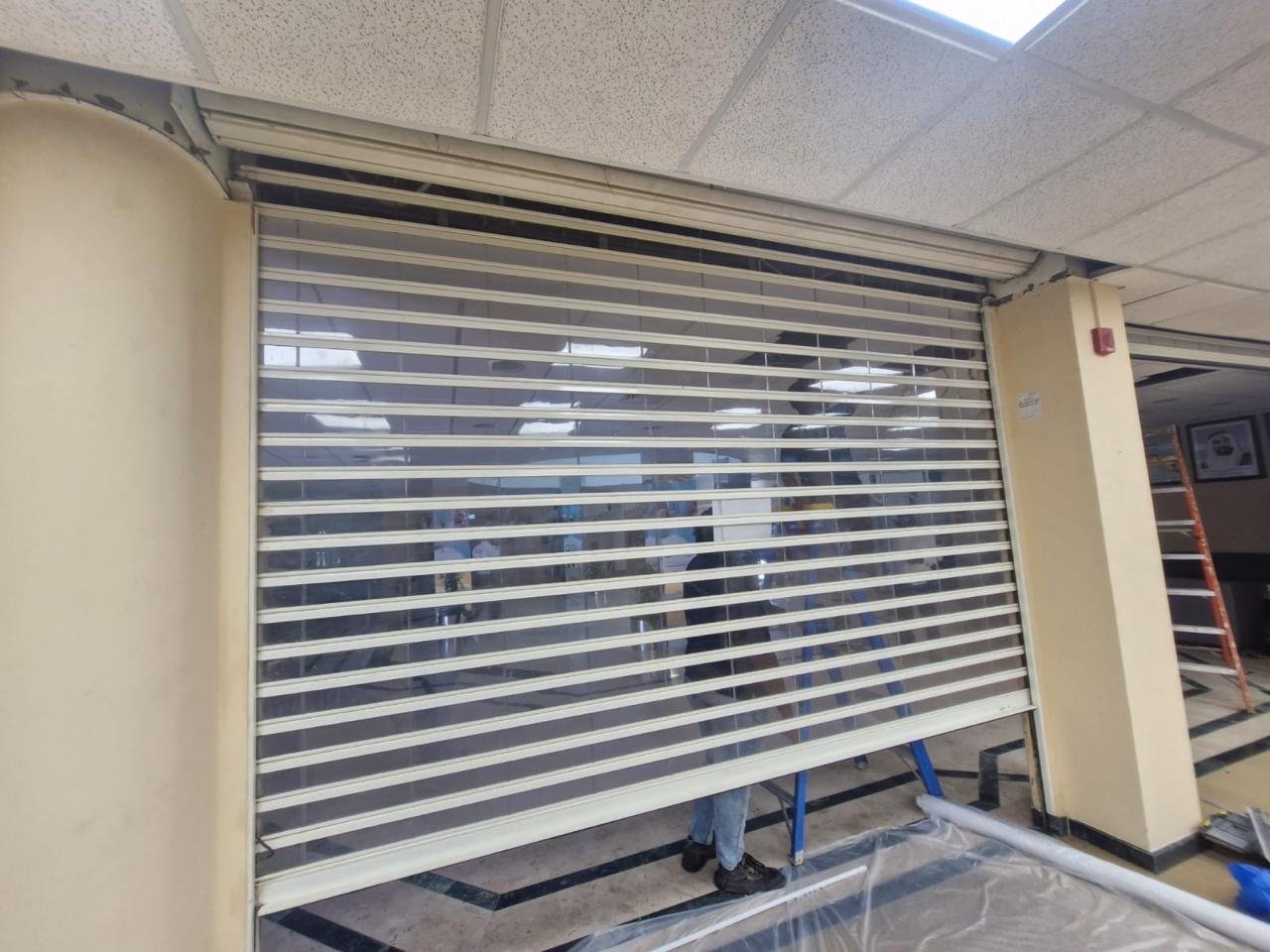 Transparent polycarbonate roller shutter on an office showroom