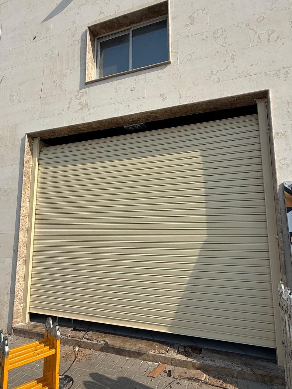 Beige rolling shutter on a garage opening